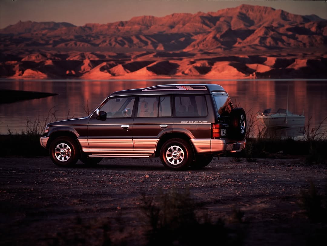 Classic Mitsubishi Pajero Intercooler Turbo at a lake shore at dusk